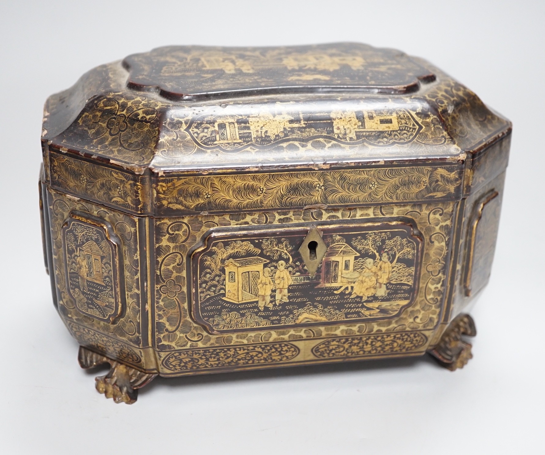 A 19th century Chinese chinoiserie lacquered sarcophagus form tea caddy, pewter lined interior with bone handles, 23cm